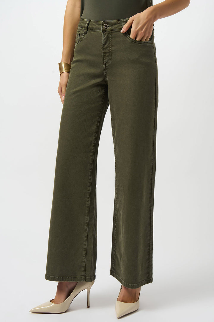 Person wearing olive green wide-leg pants on a white background