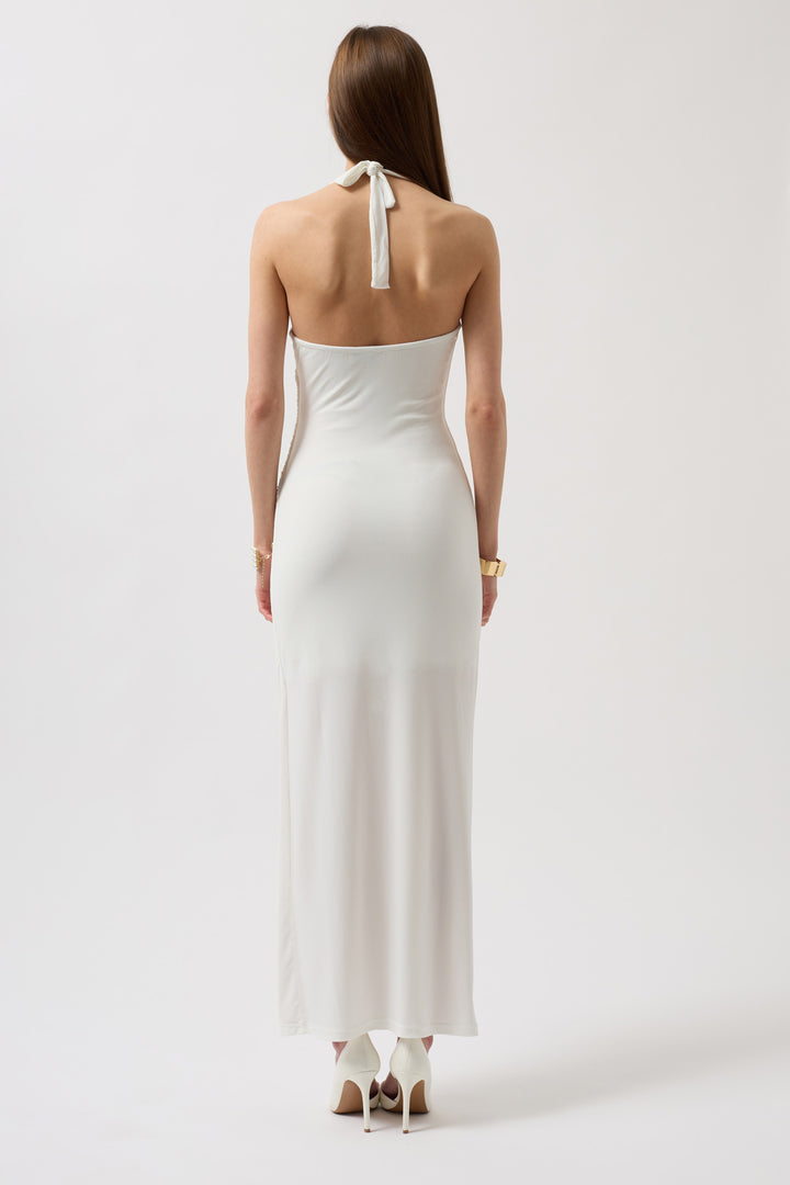 Back view of white sleeveless dress featuring low V-back and graceful movement