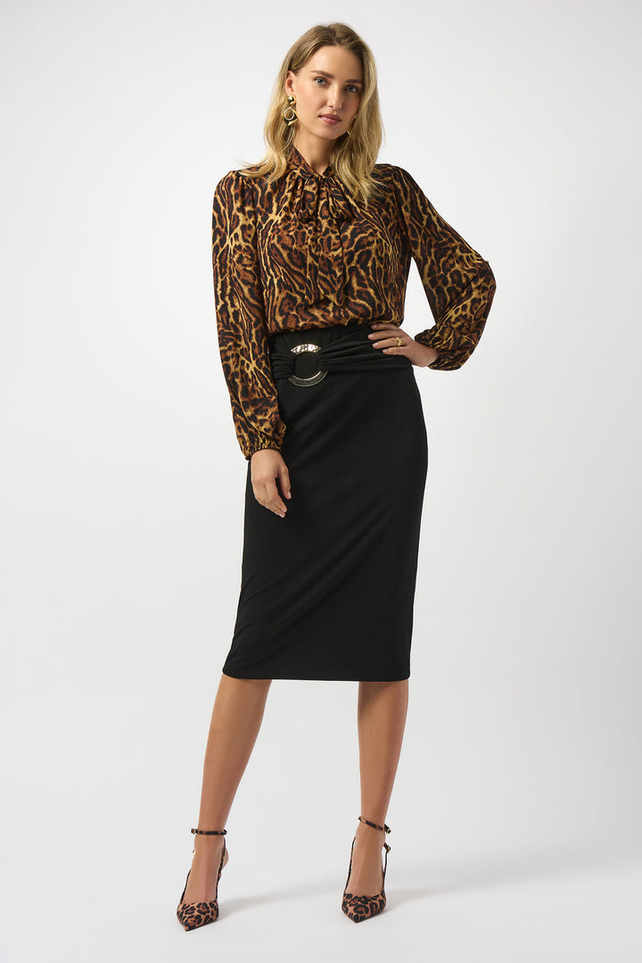 Woman wearing a leopard print blouse and black skirt on a white background