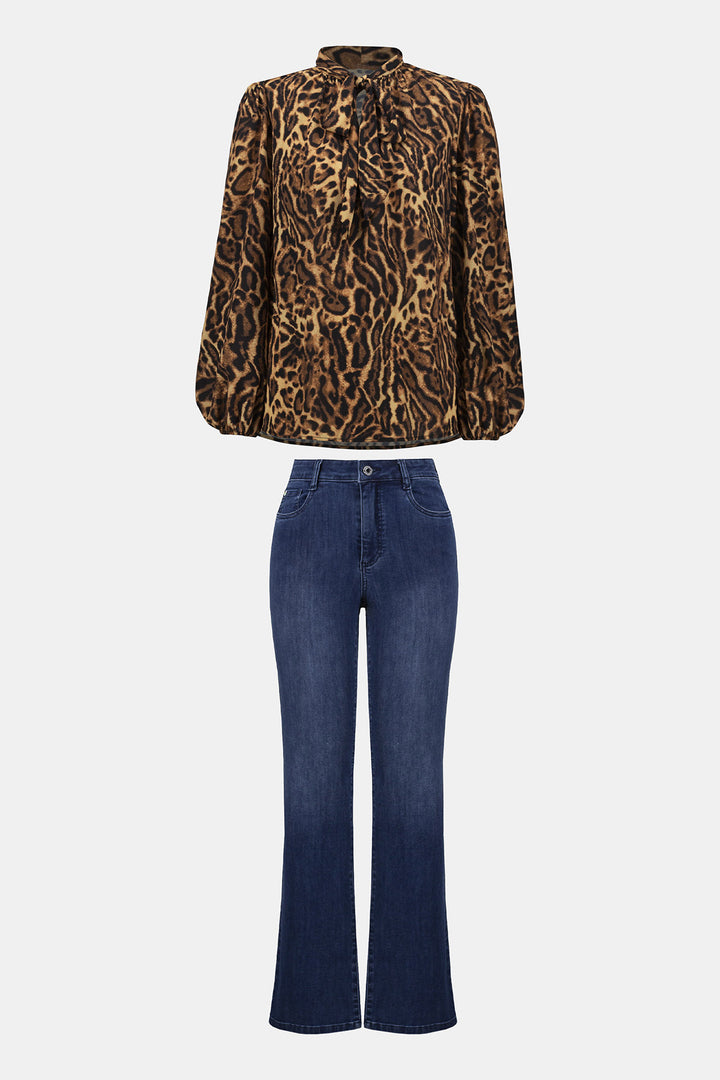 Leopard print blouse and blue jeans on a white background