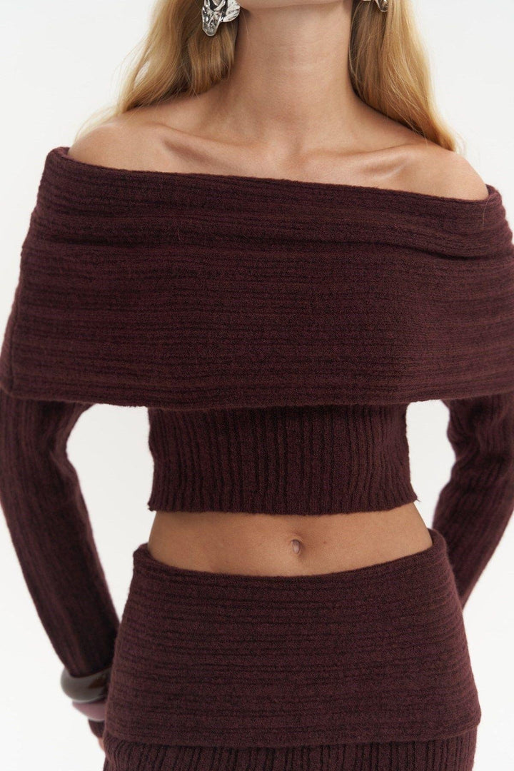 Brown off-shoulder sweater and skirt set on a plain background