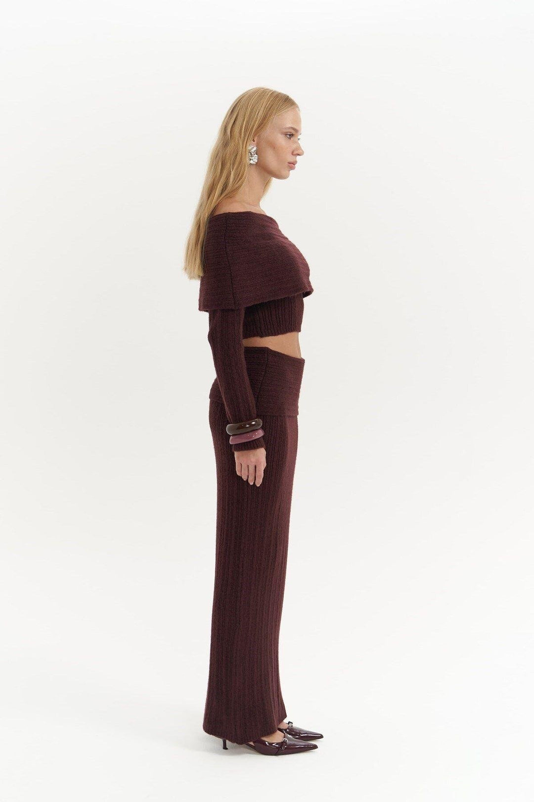 Woman wearing a brown outfit on a white background