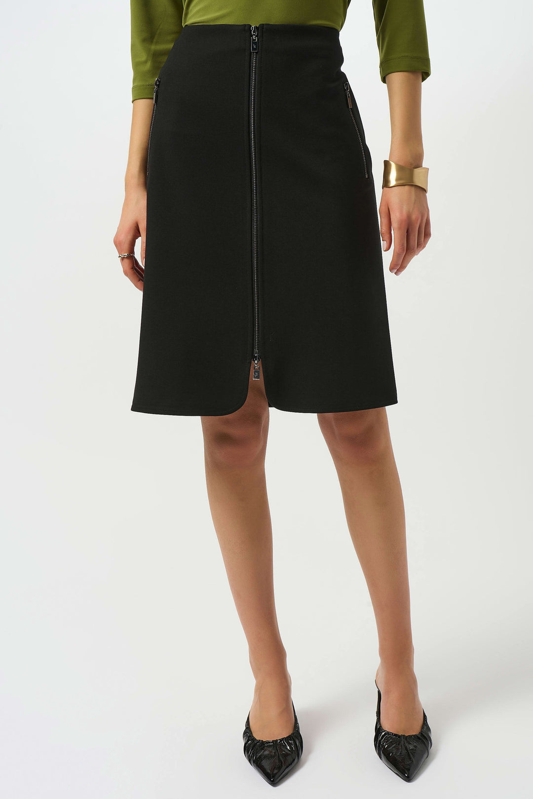 Person wearing a black skirt with a white background