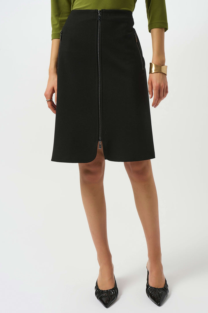 Person wearing a black skirt with a white background