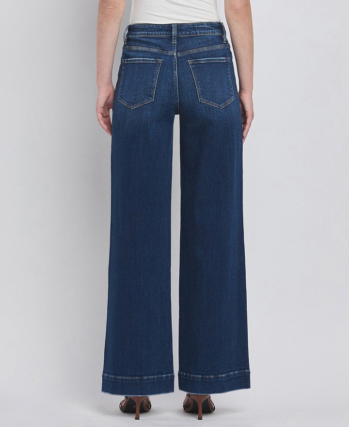 Person wearing blue wide-leg jeans on a white background