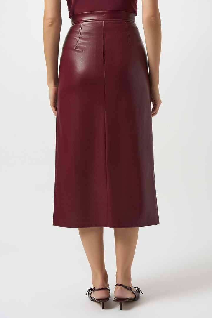 Person wearing a burgundy leather skirt on a white background