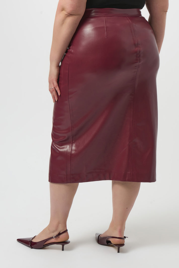 Person wearing a burgundy leather skirt on a white background