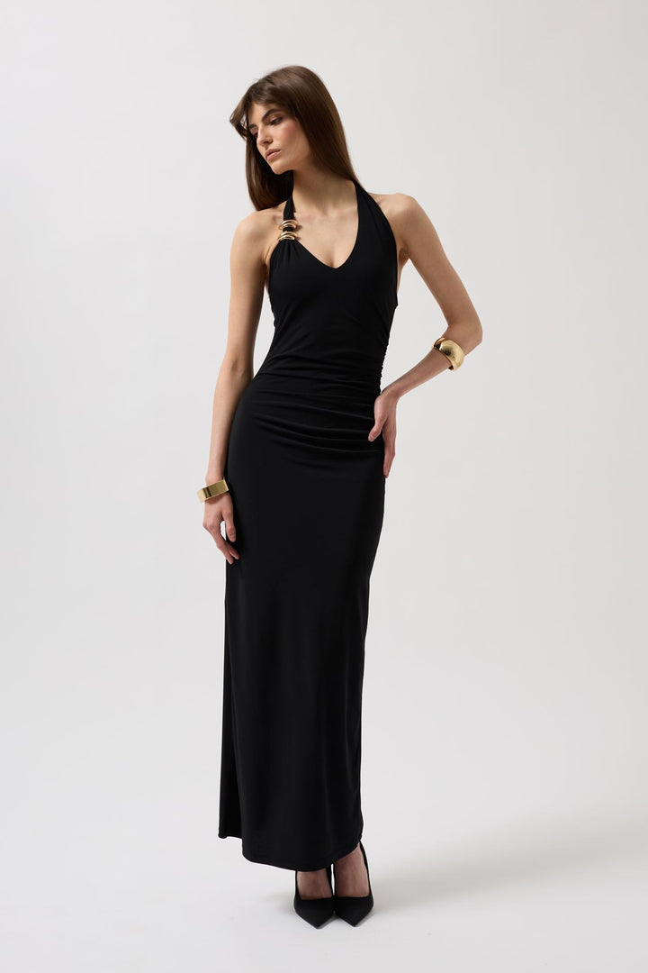 Woman wearing a black halter neck dress on a white background