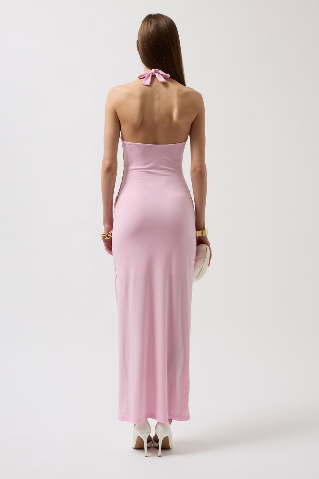 Back view of sleeveless wispy pink dress with deep V-back and gently flared hem