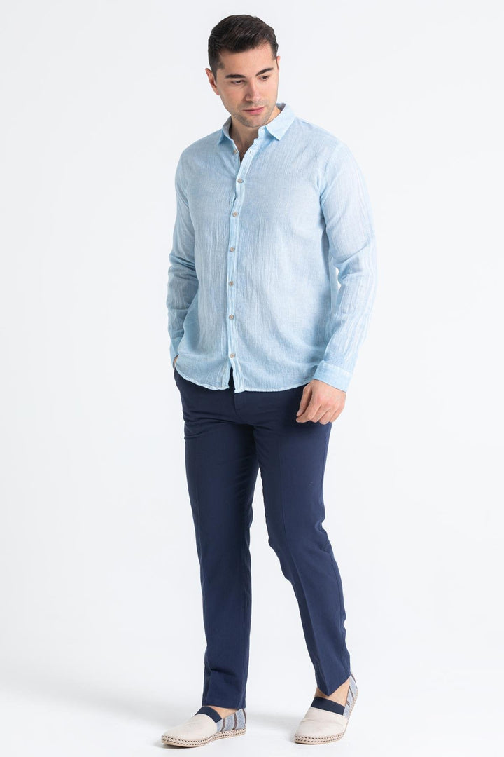 Side view of men's long sleeve shirt in Mediterranean blue with curved hem and natural drape