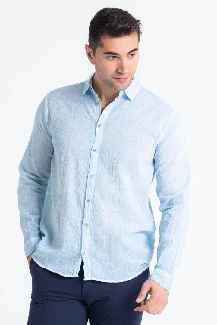 Close-up of lightweight Mediterranean blue fabric showing breathable texture and smooth weave.