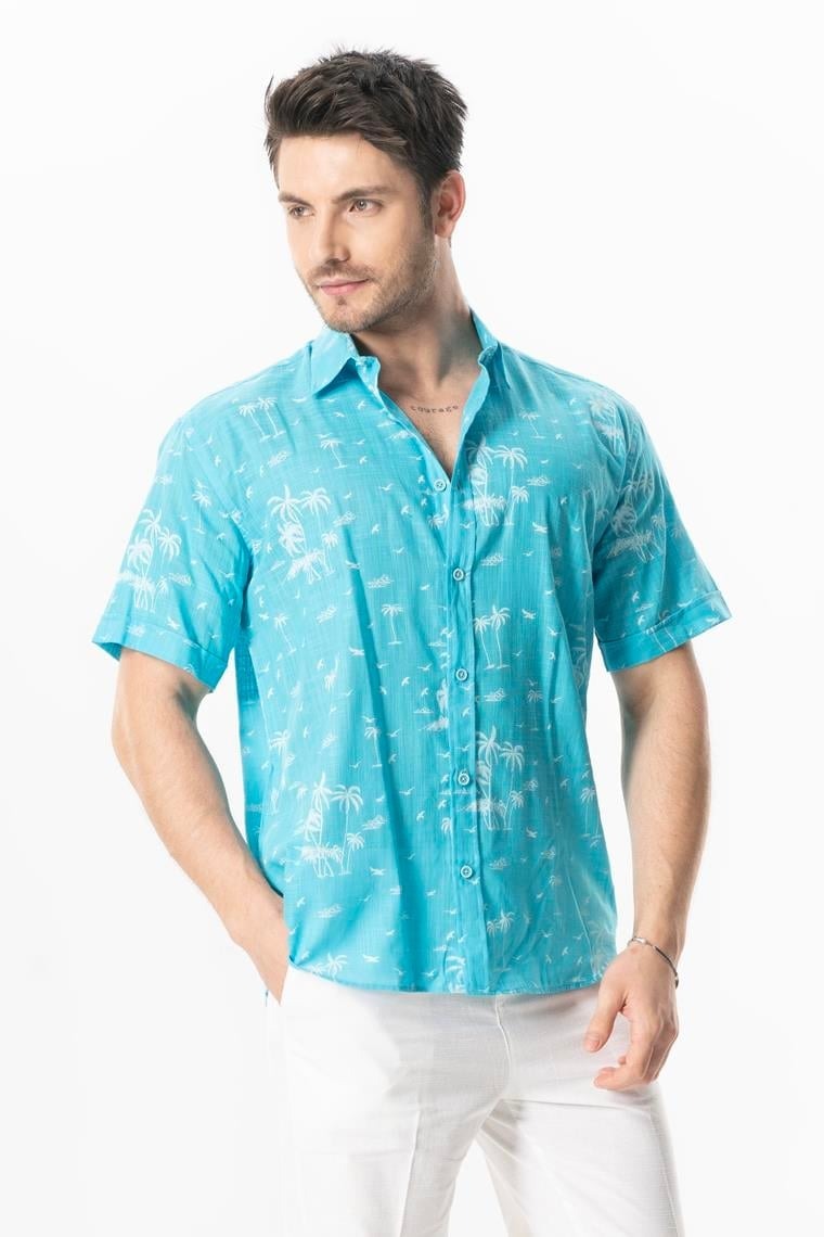 Man wearing a turquoise patterned shirt on a white background