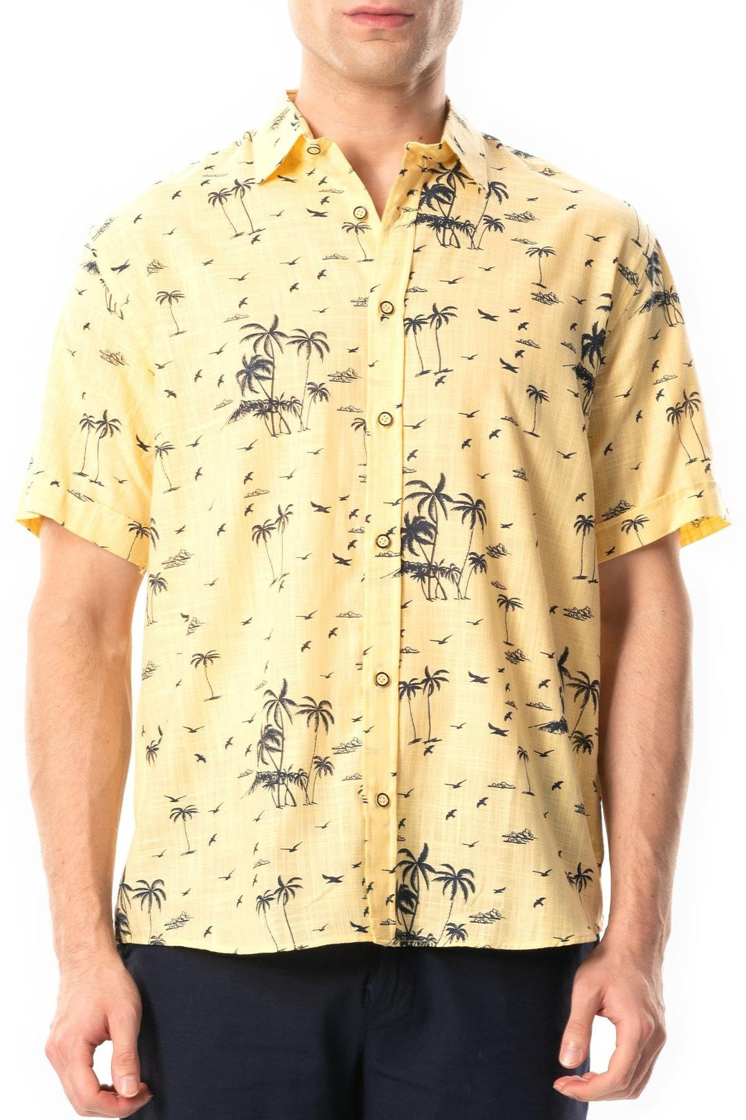 Man wearing a yellow shirt with palm tree pattern