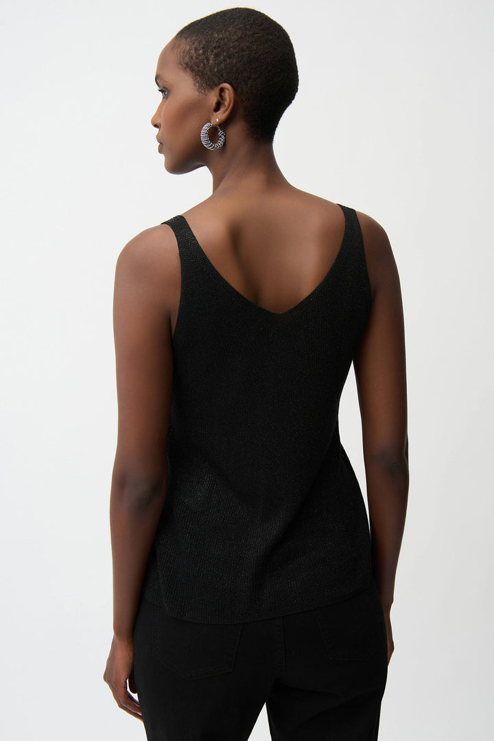 Woman wearing a black sleeveless top against a white background