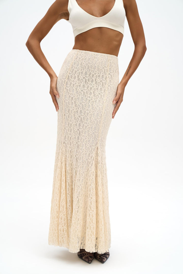 Woman wearing a white lace skirt on a white background