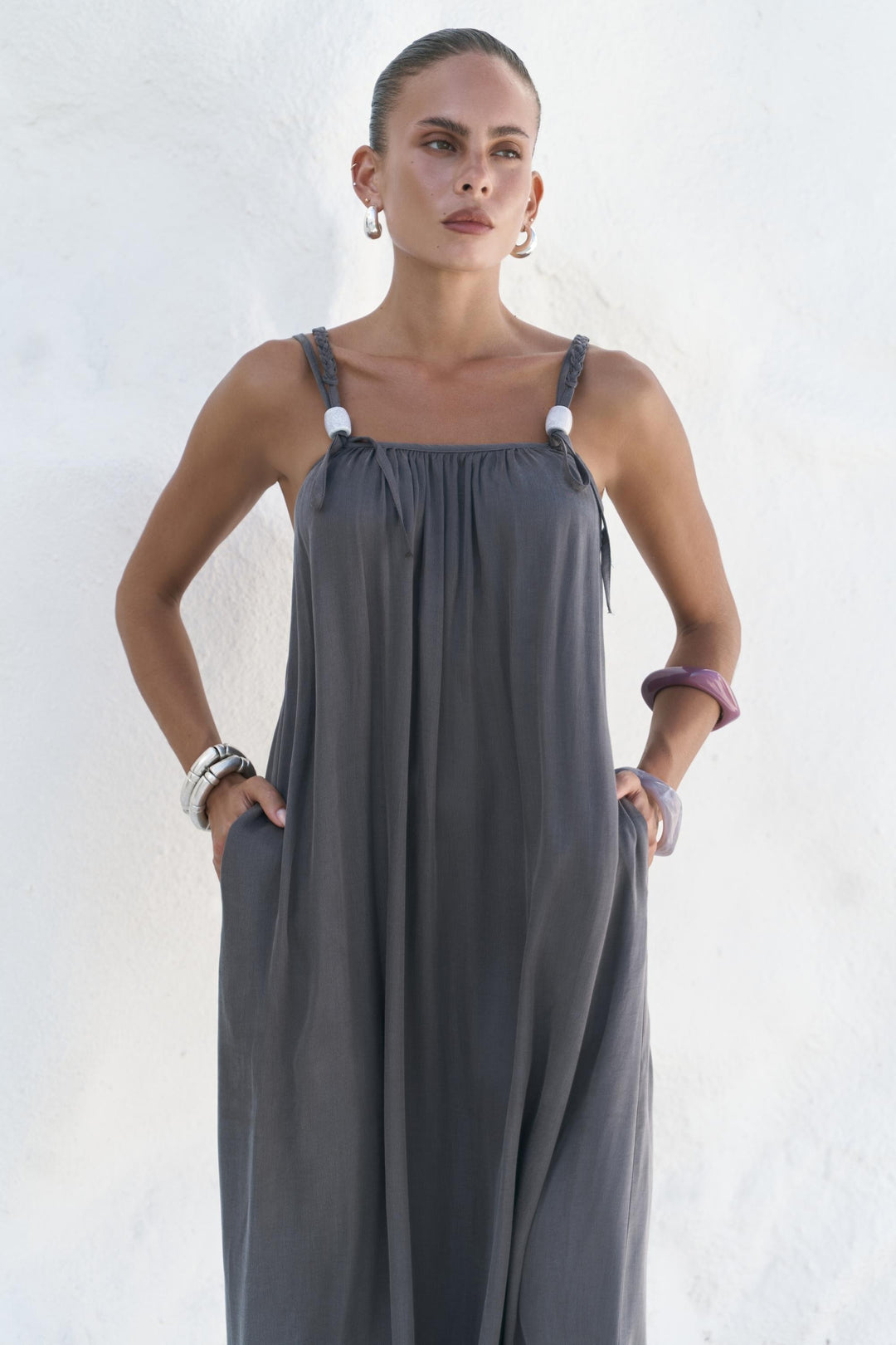 Woman wearing a gray dress against a white background