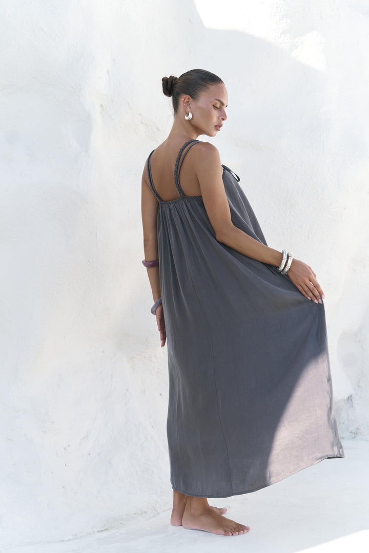 Woman wearing a gray dress against a white background