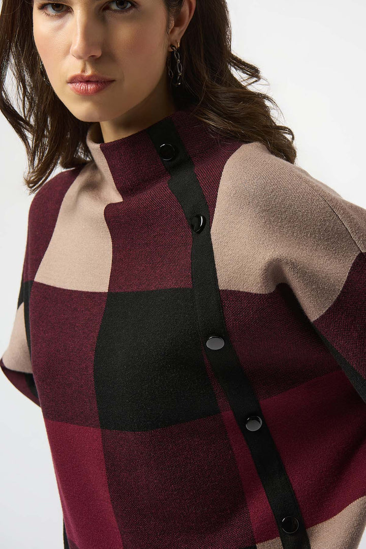 Woman wearing a checkered coat with a neutral background