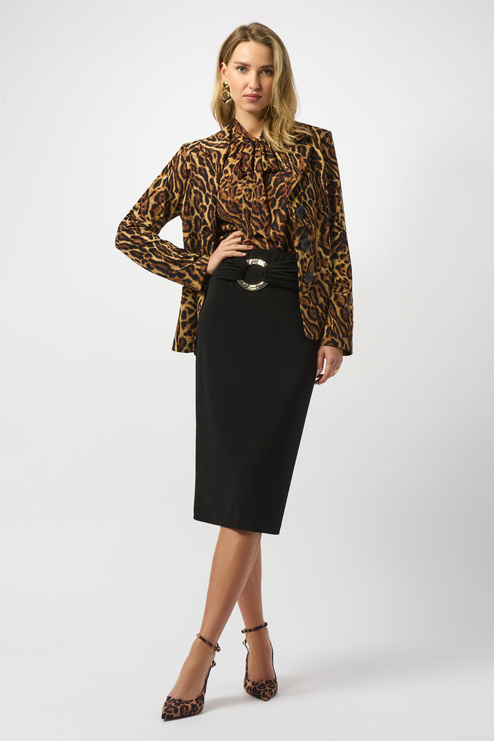 Woman wearing a leopard print blouse and black skirt on a white background