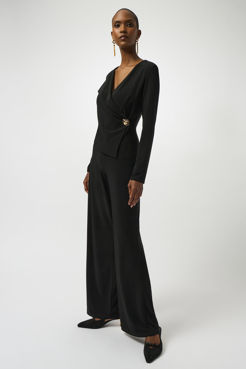 Black jumpsuit worn by a model on a white background