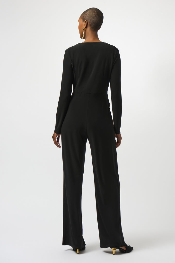 Person wearing a black jumpsuit on a white background
