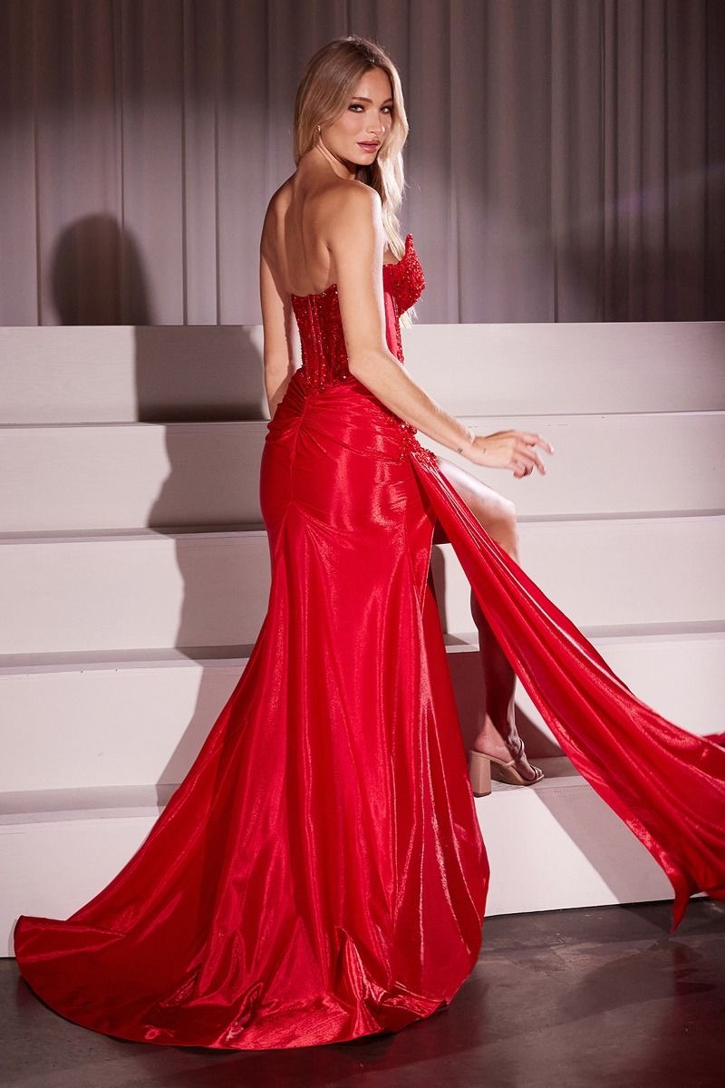 Woman in a red evening gown standing on a staircase