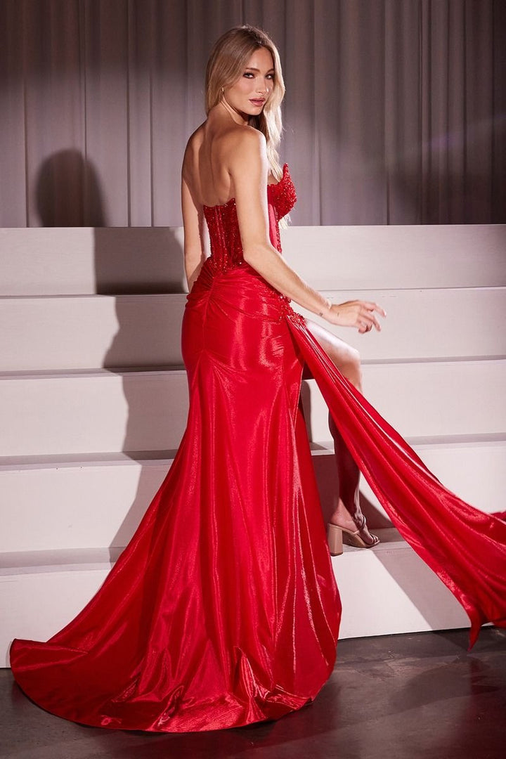 Woman in a red evening gown standing on a staircase