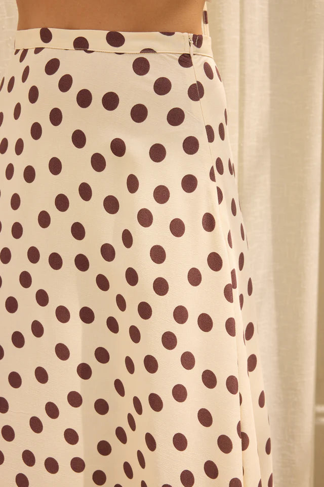 Beige skirt with brown polka dots against a neutral background