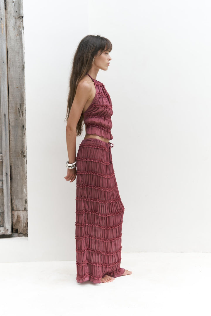 Woman wearing dusty rose matching crop top and skirt set for elegant summer resort wear styling