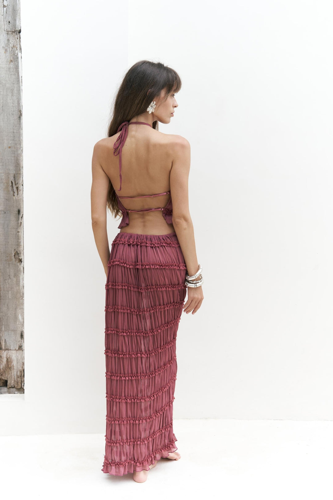 Woman wearing dusty rose matching crop top and skirt set for elegant summer resort wear styling